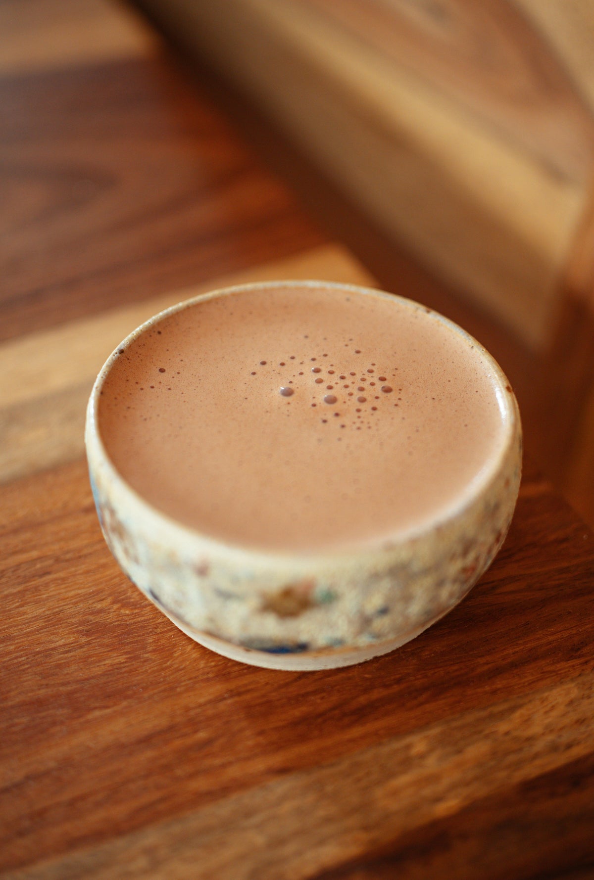 "A warm cacao drink being prepared, showcasing the ceremonial cacao ritual"